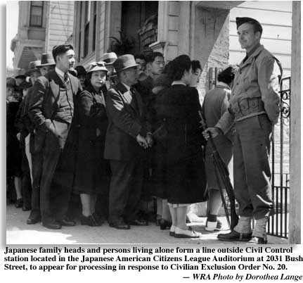 soldier guards doorway to Japanse American Citizen's League Building at 2031 Bush St. as Japanese line up for transportation under Gen. DeWitt's exclusion order no. 20. Caption by the War Relocation Authority. Photo by Dorothea Lange